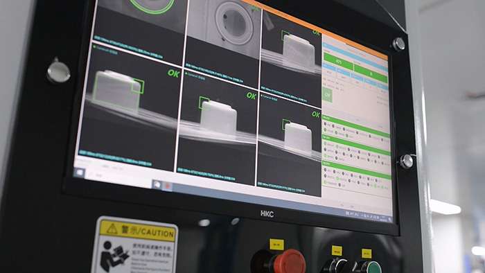 Vision inspection machine on automated production line for spray pump quality assurance and defect detection